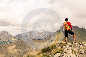 Hiking man or trail runner in mountains