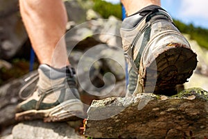 Hiking man with trekking boots on the trail