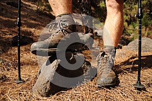 Hiking man with trekking boots on the trail