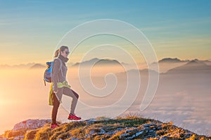 Hiking on mountain ridge in the sea of clouds