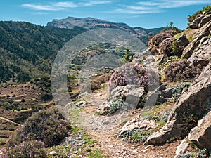 Hiking mountain trail along the slope going into the distance