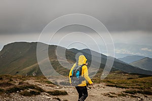 Hiker with backpack climbing at mountains