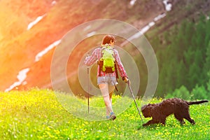 Hiking in the mountains with his dog