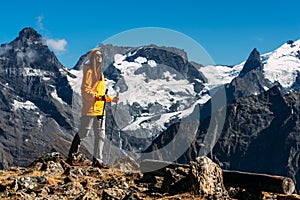 Hiking in the mountains. A person is engaged in Nordic walking in the Caucasus mountains. Copy space