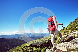 Hiking in the mountains in the summer with a backpack.