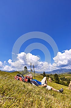 Hiking in the mountains in the summer with a backpack.