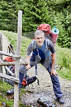 Hiking in the mountains in the summer with a backpack.