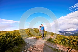 Hiking in the mountains in the summer with a backpack.