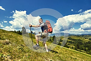 Hiking in the mountains in the summer with a backpack.