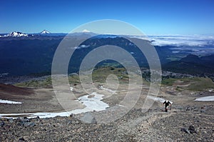 Hiking in Patagonia, Tourist walking up steep slope of volcano Puyehue, Puyehue National Park, Chile. Panoramic view