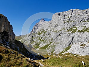 Hiking path through rocky landscape surrounded by Sulzfluh and Scheienfluh in Praettigau, Graubuenden, Switzerland.