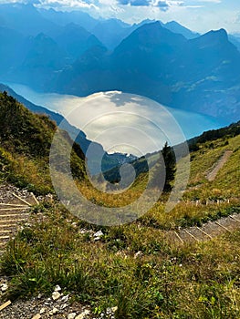 Hiking path with the stairs in Swiss Alps with the view of the lake Lucerne