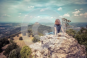 Hiking person looks at Hohenzollern Castle on mountain top, Germany