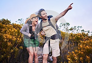 Hiking, pointing and excited couple in nature for adventure, holiday and journey on mountain. Travel, dating and man and