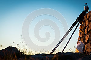 Hiking poles at wall on mountain summit