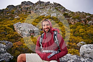 Hiking, portrait and man on mountain, nature and rock for outdoor adventure with happiness. Male person, athlete and