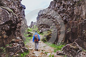 Hiking in rocky canyon, backpacker