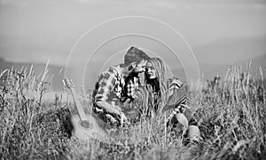 Hiking romance. Beautiful romantic couple happy smiling faces nature background. Boyfriend and girlfriend with guitar