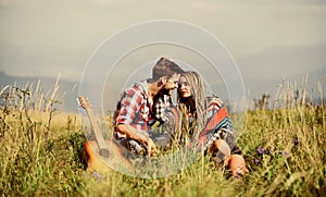 Hiking romance. Beautiful romantic couple happy smiling faces nature background. Boyfriend and girlfriend with guitar