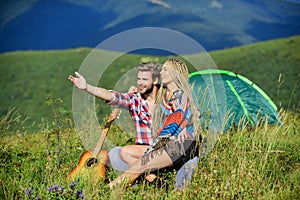 Hiking romance. Camping in mountains. Family travel. Summer vacation. Boyfriend girlfriend guitar near camping tent