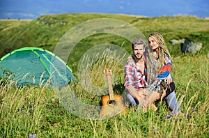 Hiking romance. Summer vacation. Boyfriend girlfriend guitar near camping tent. Couple in love happy relaxing nature