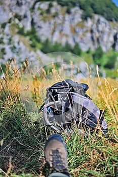 Hiking shoe and backpack in the mountain valley