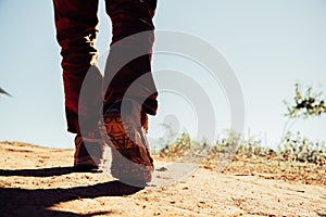 Hiking shoes in action on a mountain desert trail path.
