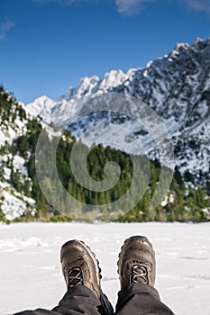 Hiking shoes on with snowy mountains in the background.