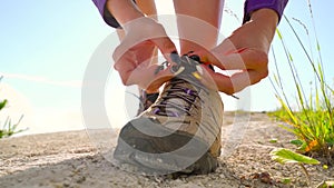 Hiking shoes - woman tying shoe laces