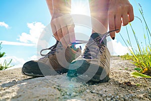 Hiking shoes - woman tying shoe laces