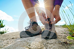 Hiking shoes - woman tying shoe laces