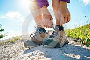 Hiking shoes - woman tying shoe laces