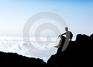 Hiking silhouette backpacker, man trail runner in mountains photo