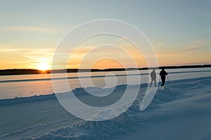 Hiking in skandinavien winter sunset on frozen lake photo
