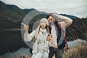 Hiking, stress and lost couple with a phone in nature for direction, map or navigation with anxiety. Backpacking, travel