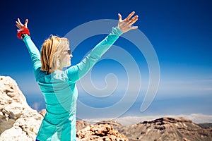 Hiking success, woman on trail in mountains