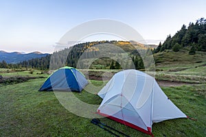 Hiking tents in the mountains set outdoor.