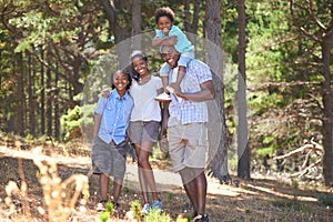 Hiking is their favorite weekend activity. Portrait of an african american family enjoying a day out in the forest.