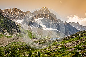 Hiking to Argentiere glacier with the view on the massif des Aiguilles Rouges in French Alps