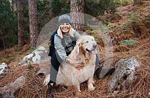 Hiking together helps us to bond. a mature woman out for a hike with her dog.