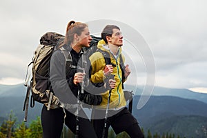 Hiking together. Woman and man. Majestic Carpathian Mountains. Beautiful landscape of untouched nature