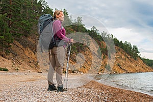 Hiking tourism adventure. Backpacker hiker woman looking at beautiful view. Hiker girl lady tourist with backpack