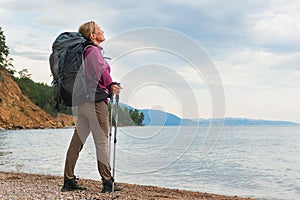 Hiking tourism adventure. Backpacker hiker woman looking at beautiful view. Hiker girl lady tourist with backpack