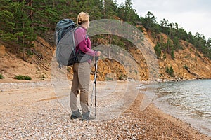 Hiking tourism adventure. Backpacker hiker woman looking at beautiful view. Hiker girl lady tourist with backpack