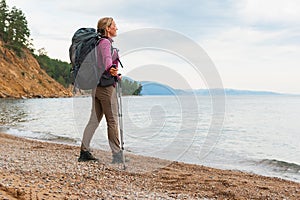 Hiking tourism adventure. Backpacker hiker woman looking at beautiful view. Hiker girl lady tourist with backpack