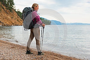 Hiking tourism adventure. Backpacker hiker woman looking at beautiful view. Hiker girl lady tourist with backpack