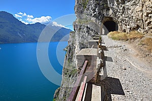 Hiking trail above lake Garda with tunnels and stunning view, old Ponale Road Riva