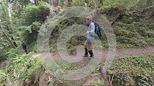 Hiking on Trail Along Cliff in Rainforest