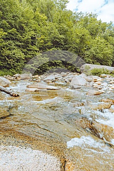 Hiking trail along river in New Hampshire mountains