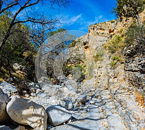 Hiking Trail Through Boulders and Streambed on The Devil\'s Hall Trail